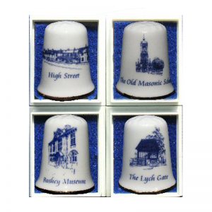 A set of four china thimbles with scenes of Bushey.